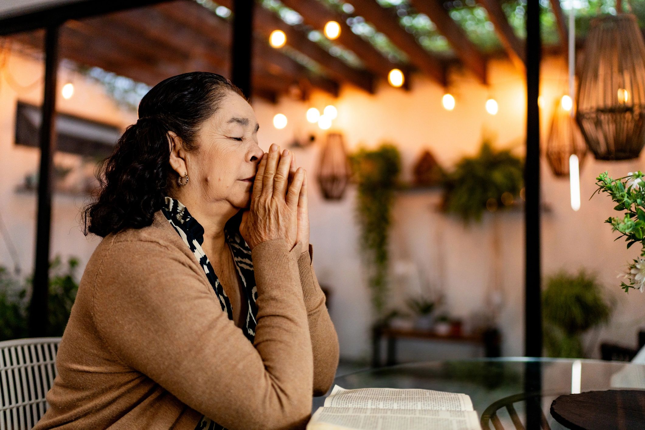 Person praying by candlelight