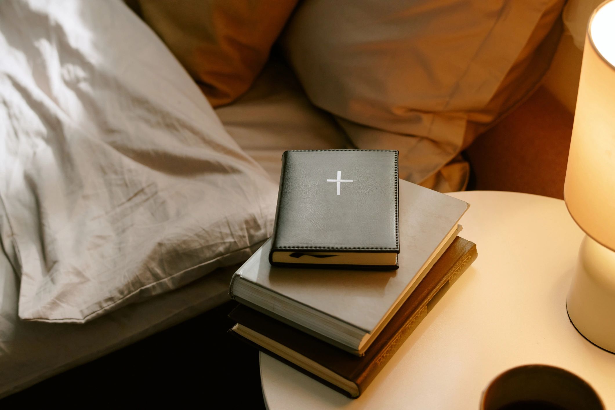 Bible resting on a bedside table in soft light