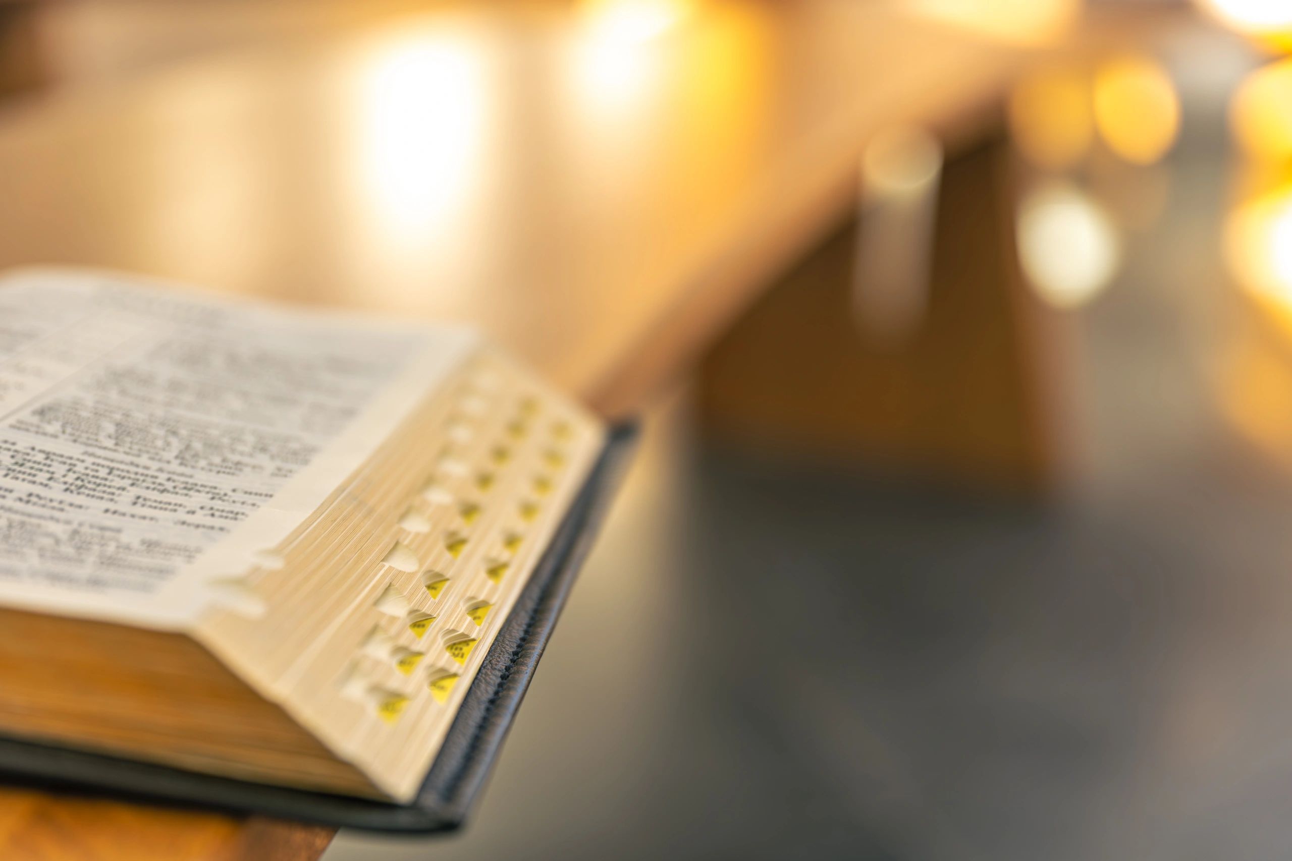 Open Bible with warm golden light and copy space