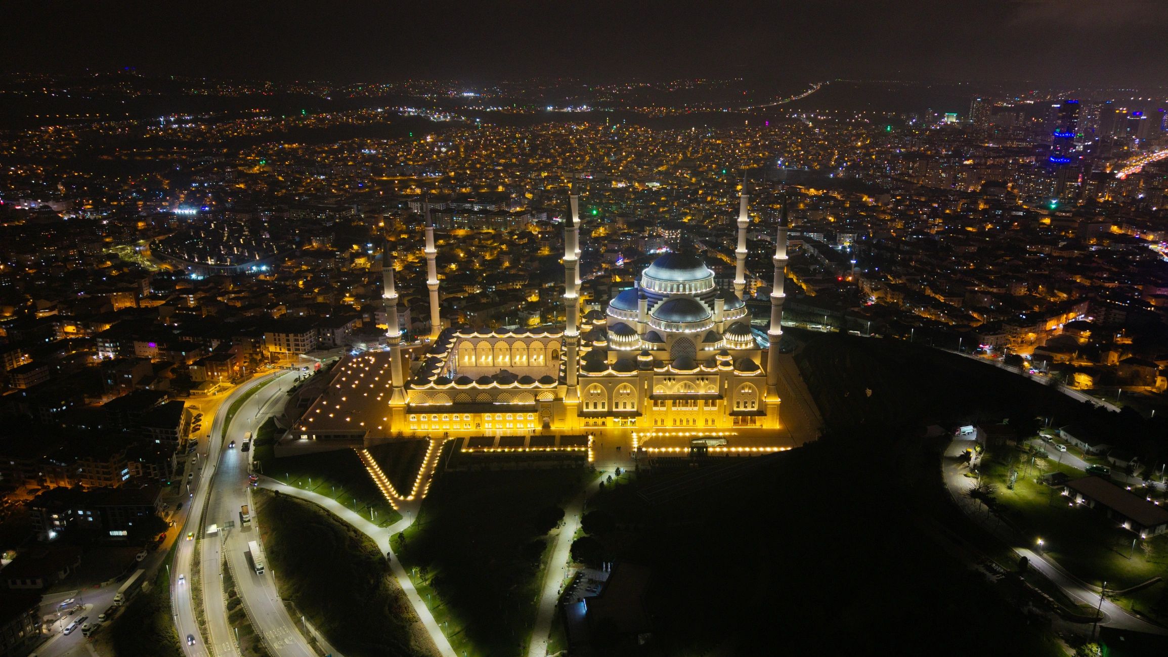 Night city skyline with illuminated mosque